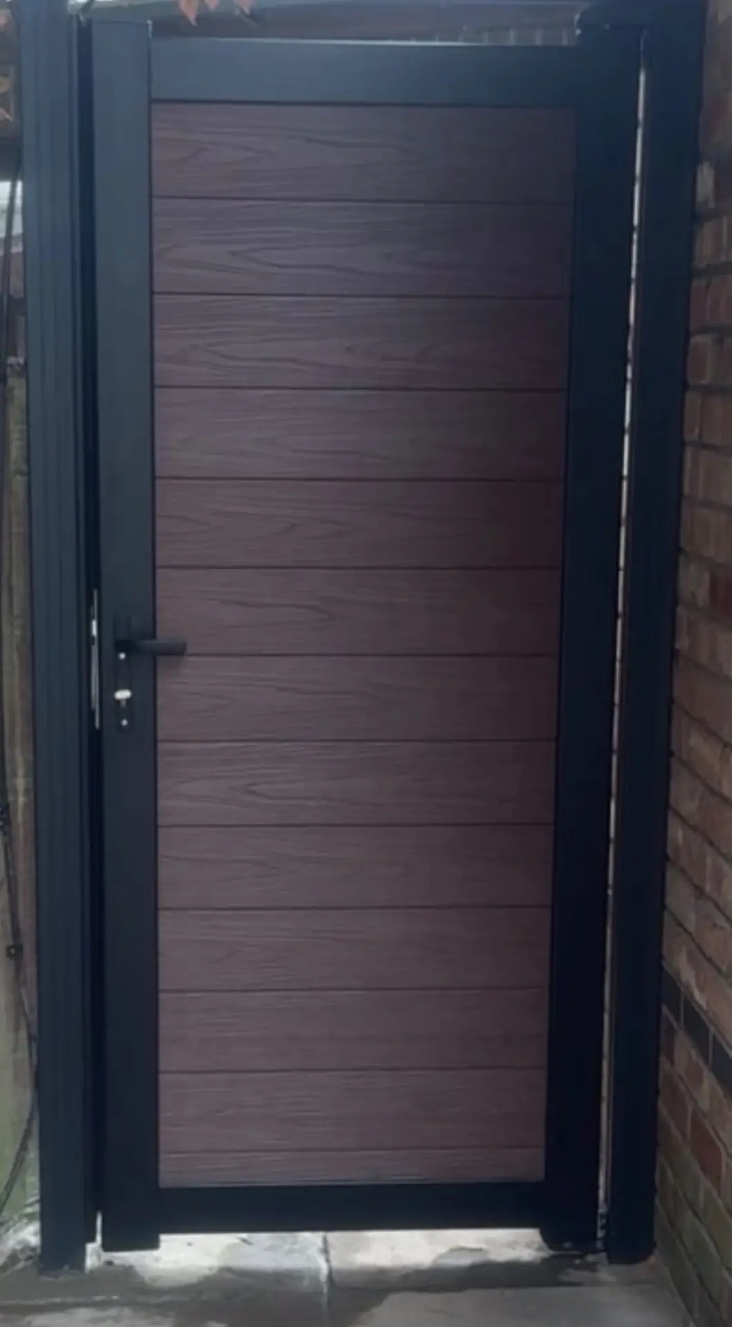 Weatherboard Fencing brown composite side gate installation.jpg